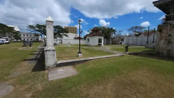 A park with a bench and lamp post in the middle of it