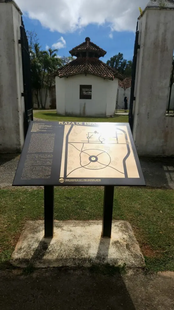 A sign in front of a building with a map on it.