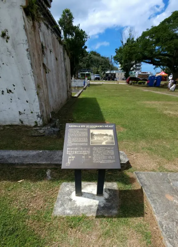 A plaque is displayed in front of an old building.