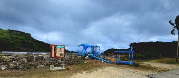 A playground with blue equipment and a sky background