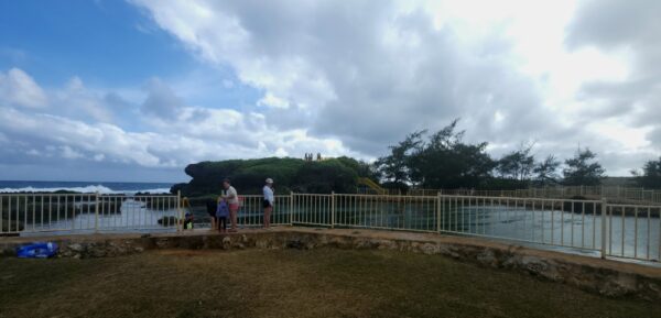 A group of people standing on top of a hill.