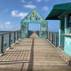 A pier with a sign on it that says welcome to petoskey.