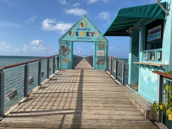 A pier with a sign on it that says welcome to petoskey.